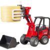 Schaeffer Compact loader 2630 with bale gripper and 1 round bale